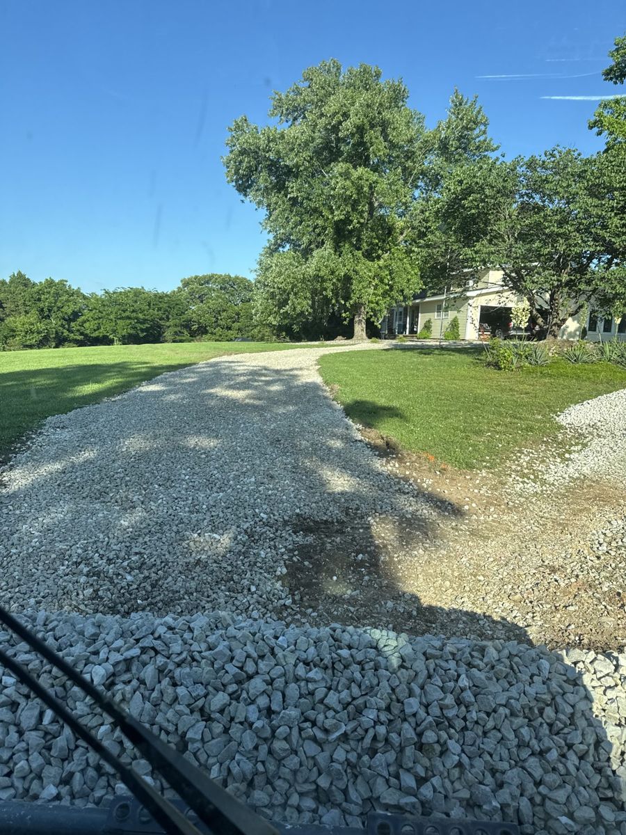 Fresh rock spread on a driveway approach.